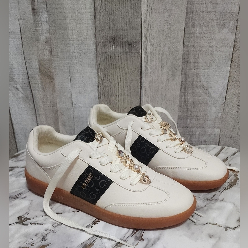 Guess Women's Cream and Black Sneakers with Gold Charm Details